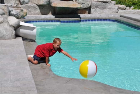 Young boy playing in a pool